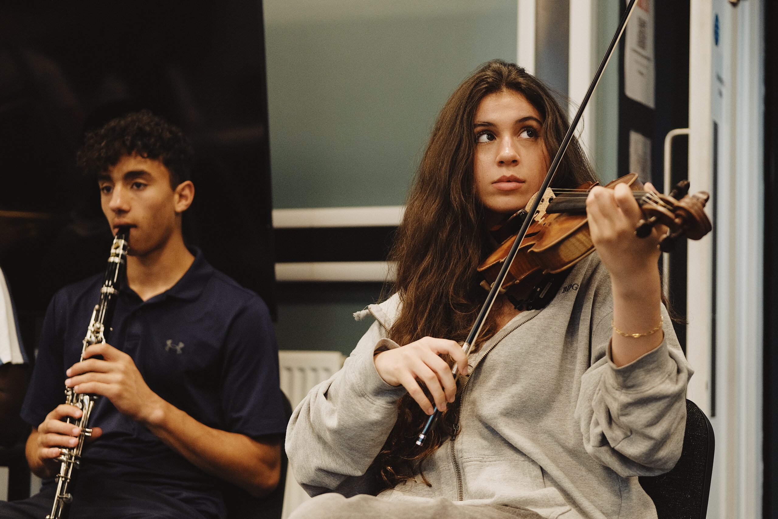 Students play clarinet and violin