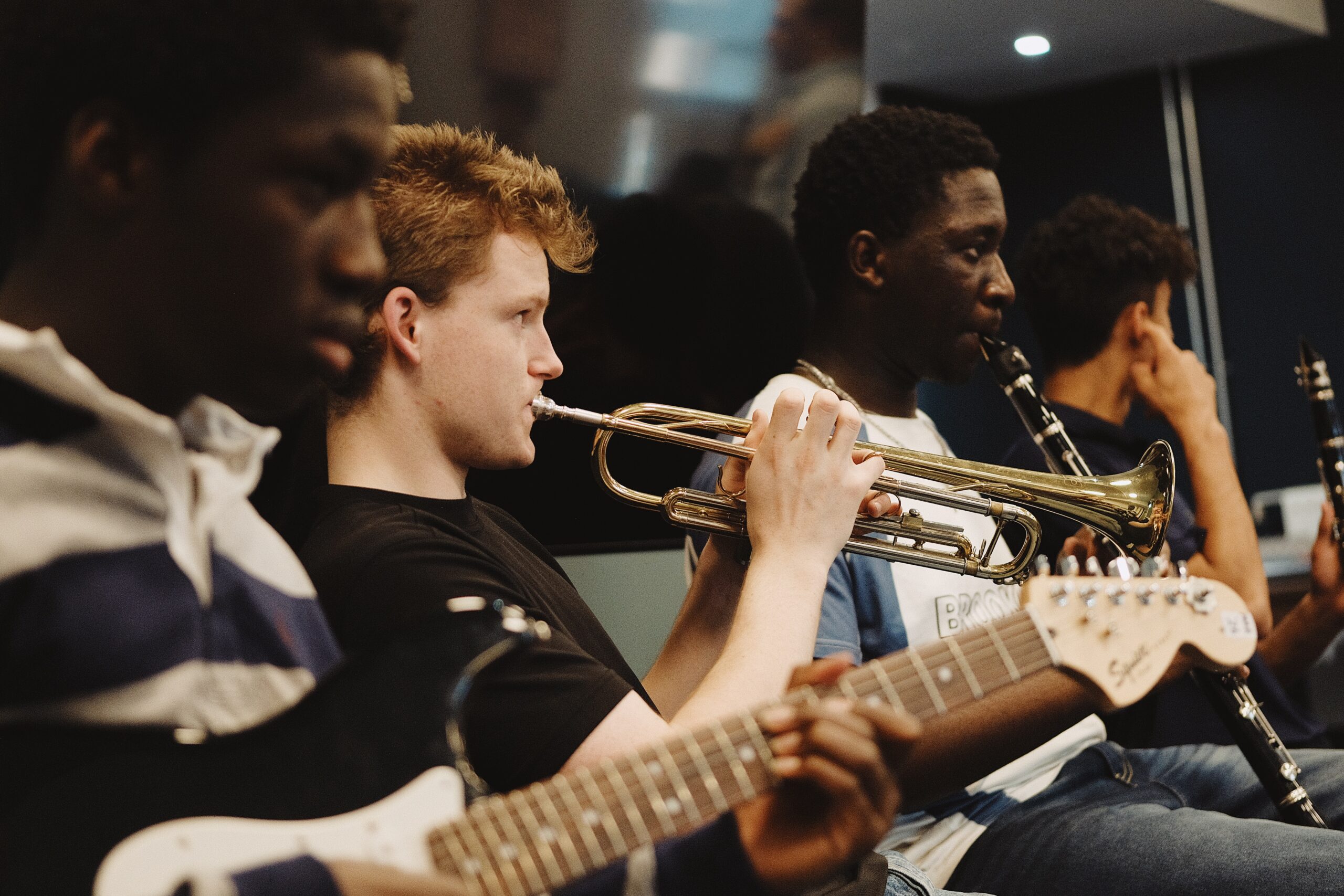 Students playing guitar and trumpet