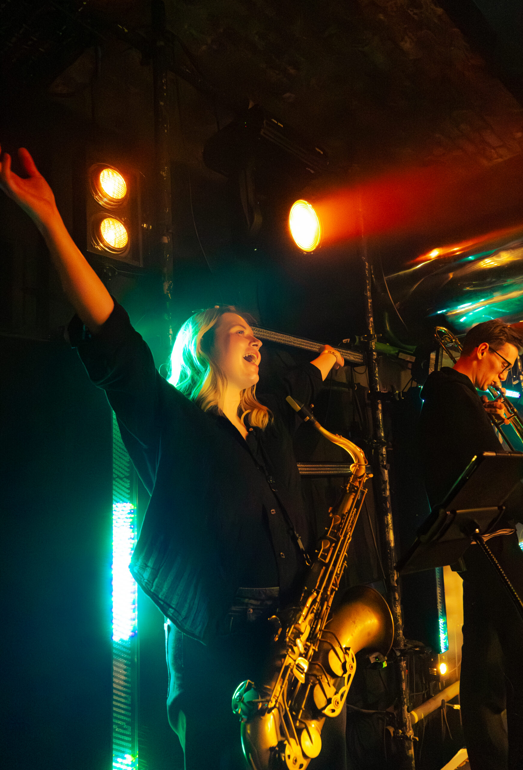 Emma Foulds stands with saxophone. Emma Foulds stands with saxophone.