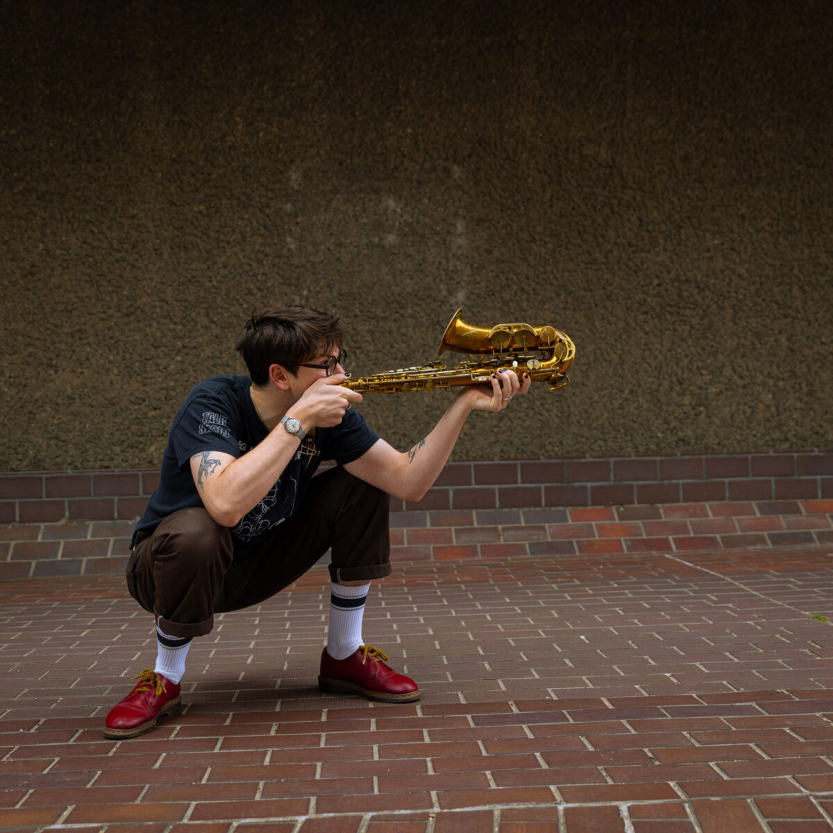 Jamie Harms holds saxophone.