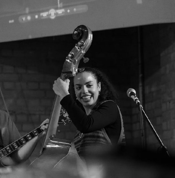Macy Wright plays double bass. Macy Wright plays double bass.